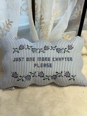 Embroidered “just one more chapter” deco pillow